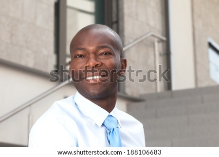 Laughing african businessman on stairs