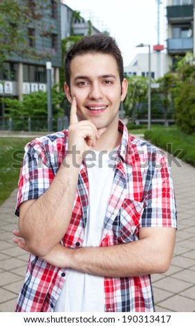 Laughing student with checked shirt