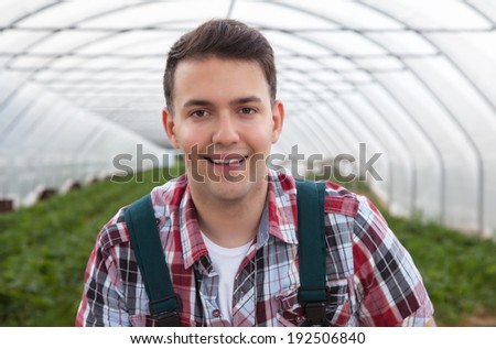 Attractive farmer laughing at camera