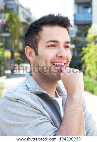 Student in a grey jacket outdoors dreaming on a summer day