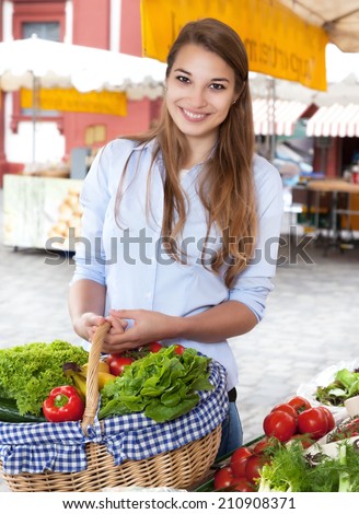 Young woman buying fruits and vegetables