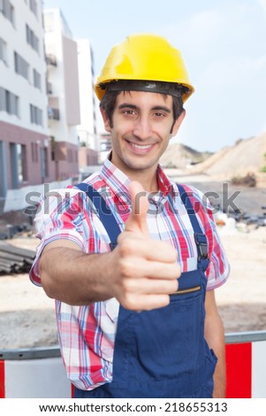 Construction worker with black hair showing thumb up