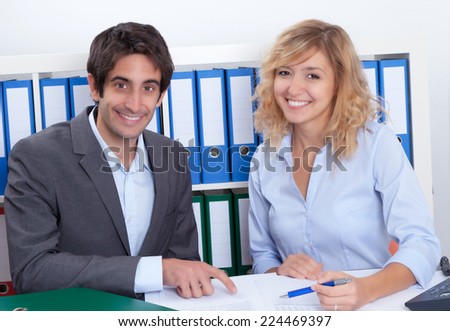 Young business team at office laughing at camera