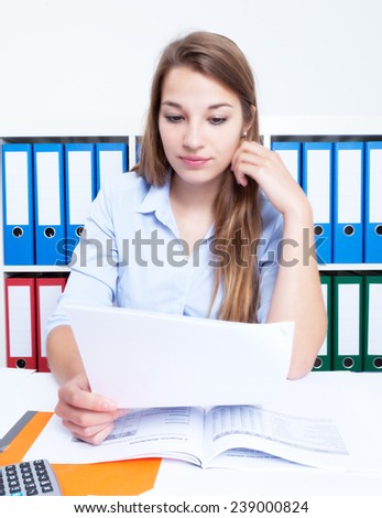 Reading woman with blond hair and letter at office