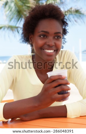 Beautiful brazilian woman at beach drinking soda