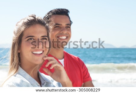 Happy latin couple at beach