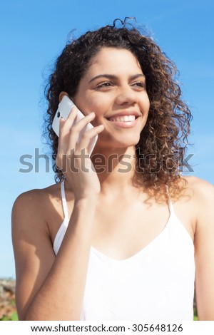Beautiful latin woman speaking at phone