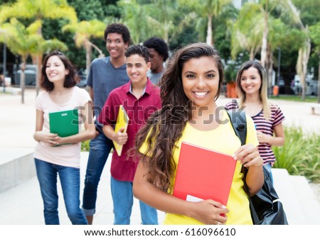 Latin american female student with group of international students