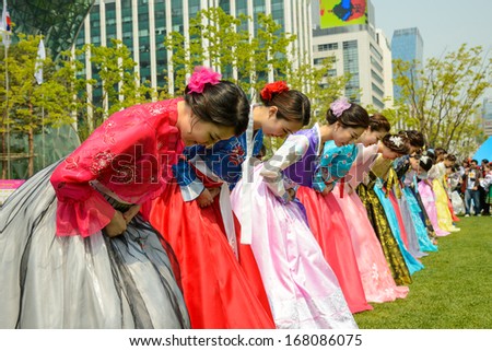 SEOUL, SOUTH KOREA - MAY 4: Korean Models wearing Hanbok, the Korean traditional dress, take a bow during the photo session in front of Seoul City Hall at Seoul Friendship Fair on May 4, 2013.