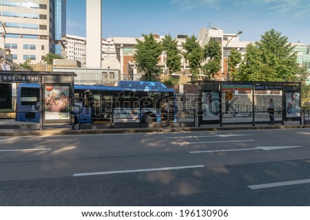 SEOUL, SOUTH KOREA - MAY 29: People are boarding the bus at bus stop in front of Changgyeonggung palace in Seoul, South Korea, on May 29, 2014.