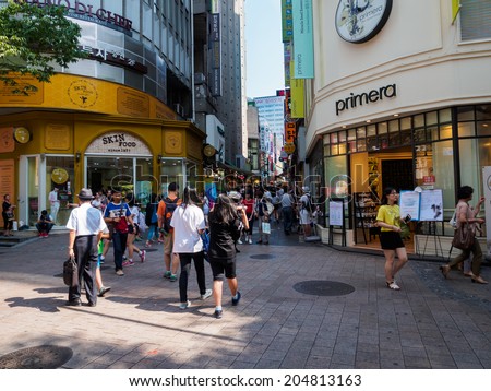 SEOUL, SOUTH KOREA - JULY 11: People are shopping in Myeongdong commercial area in Seoul. Seoul Tourism Organization organizes Seoul Summer Sale event during the whole month of July 2014.