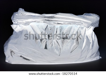 negative tied black rubbish bag isolated on white background