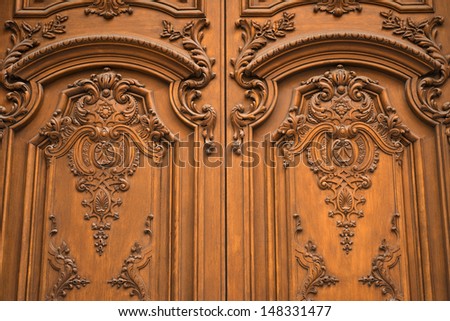 Luxuriously decorated old wooden door.