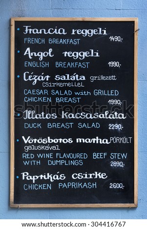 Menu board on the outside of a Hungarian restaurant.