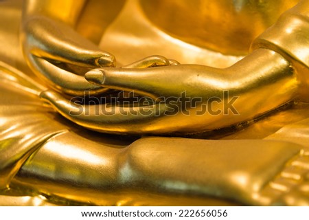 Close up hands of golden buddha