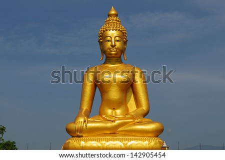 A golden buddha statue sits in peaceful meditation
