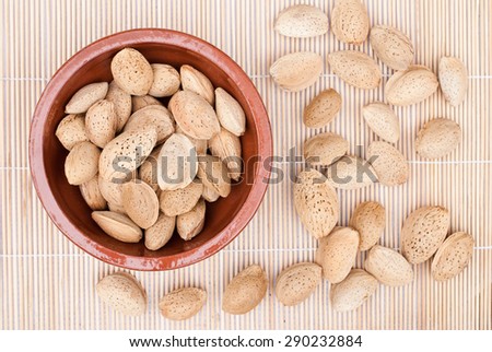 close up of isolated almonds on natural background - studio shot