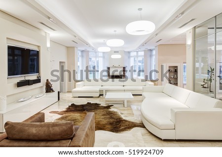 Big and comfortable living room with white interior in luxury mansion