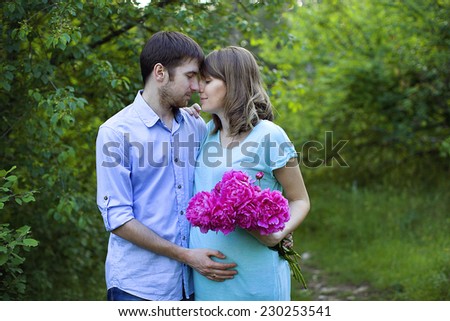 happy couple waiting for a baby, outdoors walk, couple in love