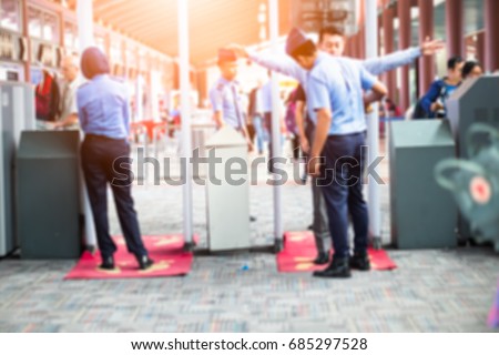 Blurred Airport security check at gates with metal detector and scanner