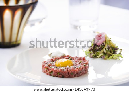 finely plated steak tartar with salad