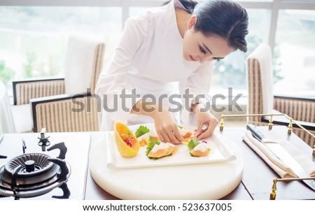 pretty charming elegant asian Japanese female chef woman cook lady prepare French cuisine meal, trendy vogue wasted girl model in chef uniform kitchen clothing as fashion portrait