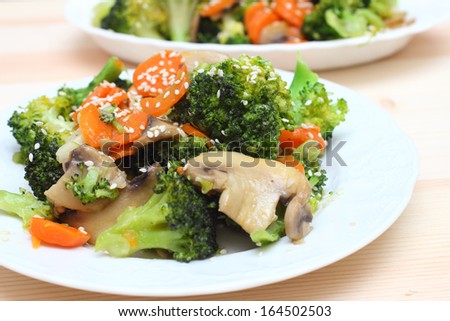 Diet food with broccoli, carrot, mushrooms and sesame seeds