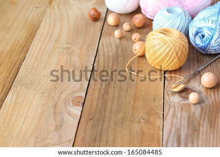 Materials for needlework on wooden table