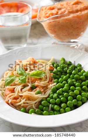Healthy Vegan meal. Pasta with tomato sauce and green peas