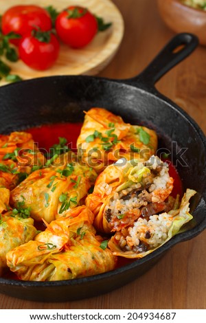 Stuffed cabbage rolls with rice and mushrooms in tomato sauce. Dolma, sarma, or golubtsy - traditional dish of many countries