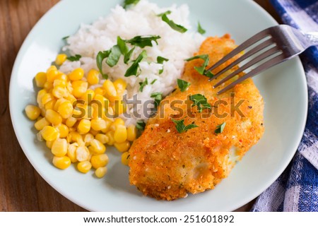 Cooked rice, corn and fried cabbage with bread crumbs - vegan version of schnitzel