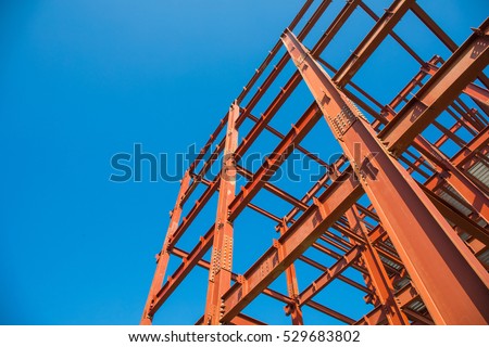 Steel beam construction pointing to the blue sky