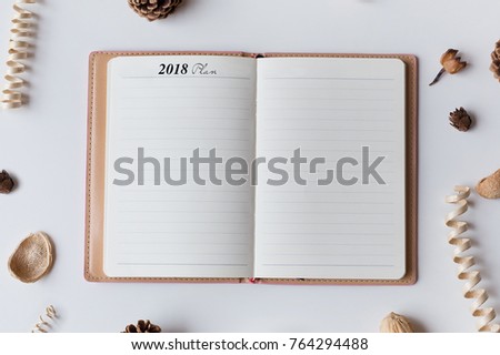 Conceptual,notebook,pinecone on a with table. open diary with to do list 2018 Plan words