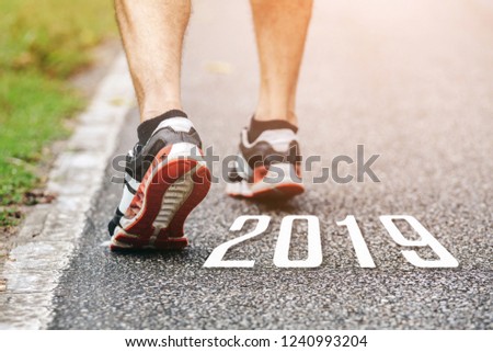 New Year 2019 Concept.Close up shot of Runner man feet running on road.