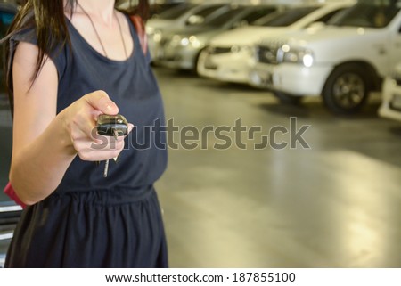 Hand with a Car keys in car park
