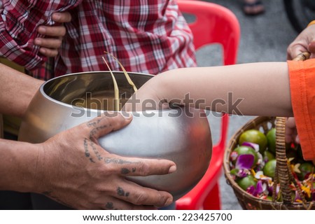 Buddhist monks are given food offering from people for End of Buddhist Lent Day