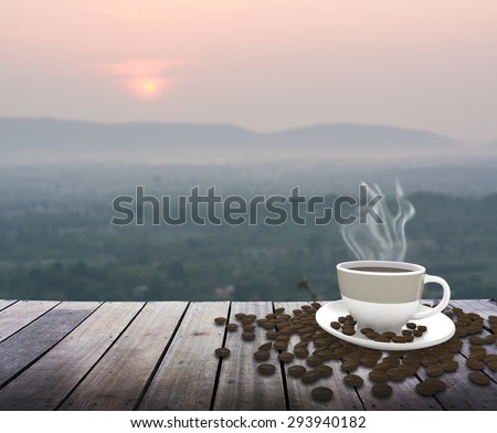 Cup with coffee on table over mountains landscape with sunrise