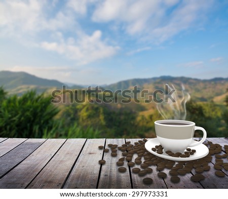 Cup with coffee on table over mountains landscape