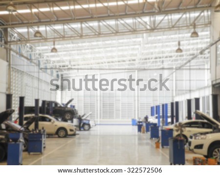 Blurred background : Car technician repairing the car in garage