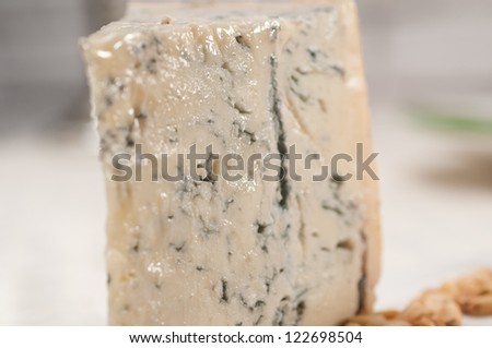 piece of Italian gorgonzola cheese fresh cut and pinenuts