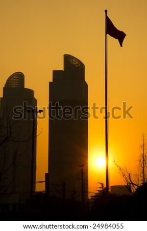shanghai twins towers over an orange sky during sunset