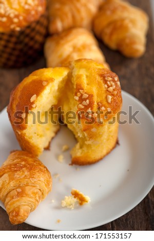 fresh baked muffin  and croissant mignon on old wood table