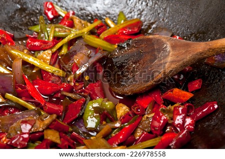 fried chili pepper and vegetable on a iron wok pan
