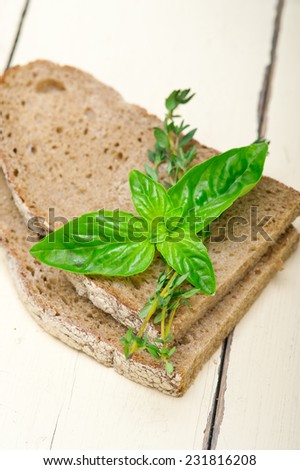 rustic Italian bread basil and thyme simple snack on white wood table