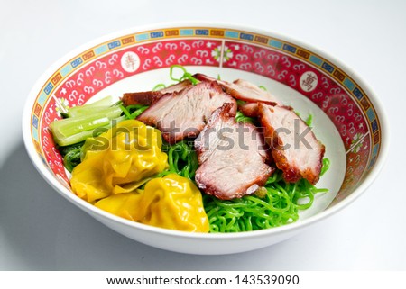 Green noodles with BBQ red pork and dumpling and chinese cabbage.
