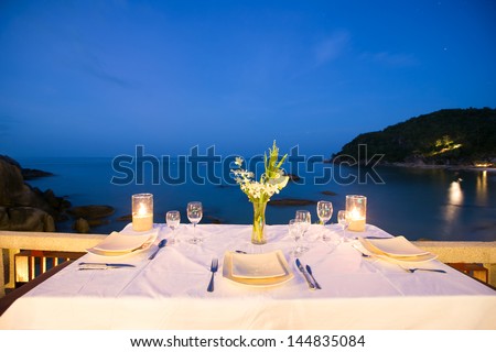 Table setting at beach restaurant in twilight time.
