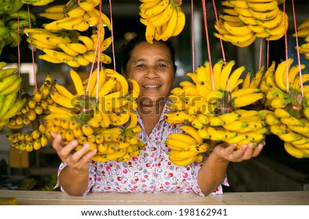 CHUMPHON, THAILAND - MARCH 13 : Unidentified woman is selling Lady Finger Bananas on March 13, 2014 in Chumphon, Thailand. Lady Finger Banana is the most famous fruit in Chumphon.