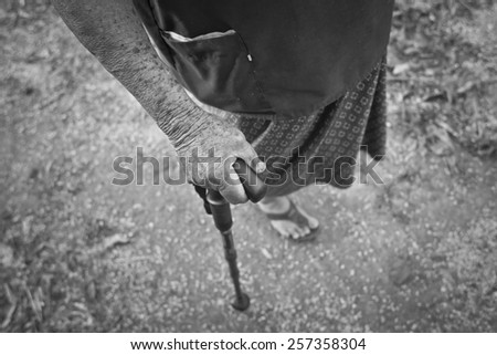 Hand of old woman holding a cane (Black and white picture)