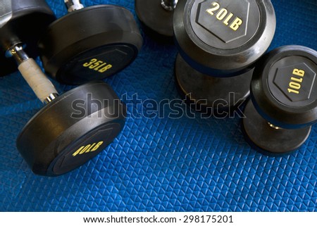 weight lifting equipment on blue gym mat