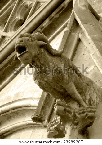Gothic style Gargoyle on St Vitus\' Cathedral Prague. Wild goat. Sepia